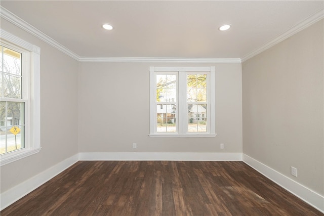 unfurnished room featuring dark wood-type flooring, ornamental molding, and a wealth of natural light