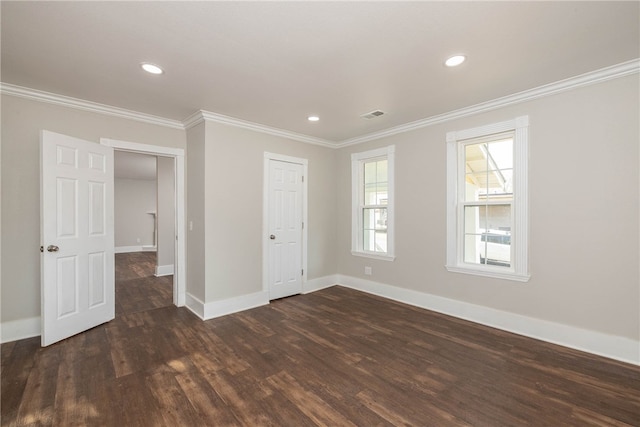 empty room featuring crown molding and dark hardwood / wood-style flooring