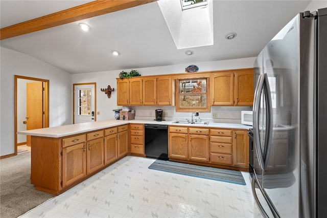 kitchen with black dishwasher, lofted ceiling with skylight, white microwave, freestanding refrigerator, and a peninsula