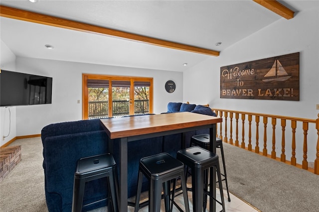 bar with carpet floors, lofted ceiling with beams, and baseboards