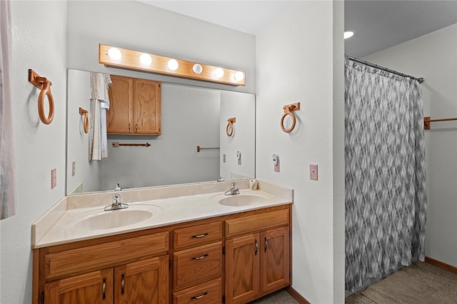 bathroom featuring baseboards, a sink, a shower with shower curtain, and double vanity