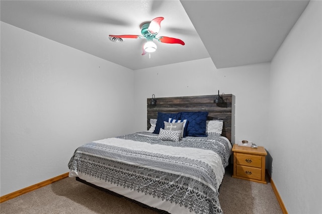 carpeted bedroom with ceiling fan and baseboards