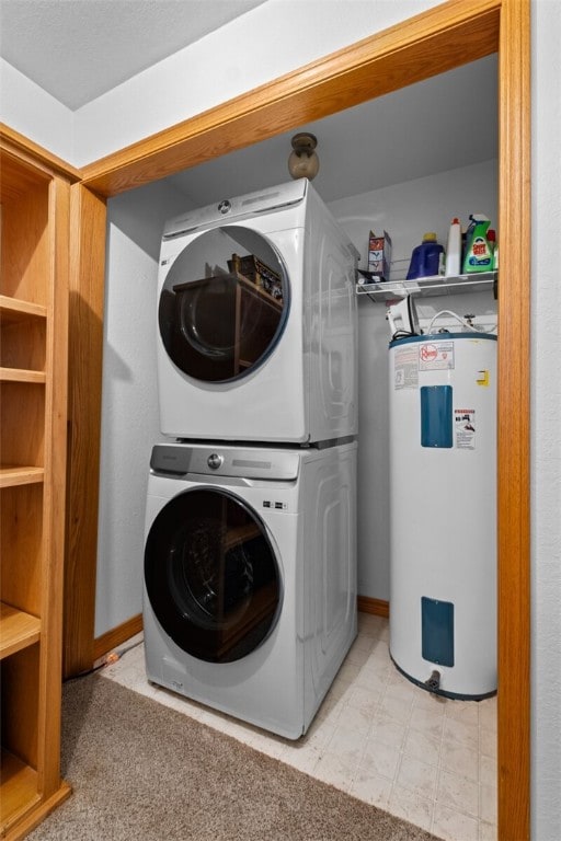 laundry area with electric water heater, laundry area, light floors, and stacked washer and clothes dryer