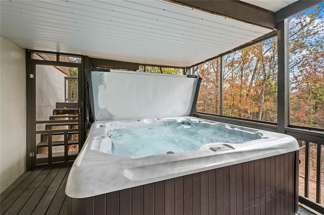 sunroom with plenty of natural light and a jacuzzi