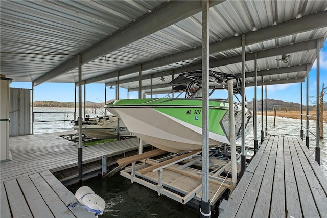 view of dock featuring a water view and boat lift