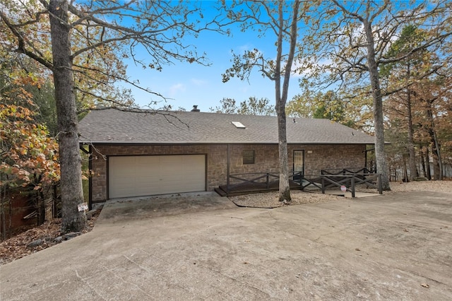 view of front of house featuring a shingled roof, driveway, and an attached garage