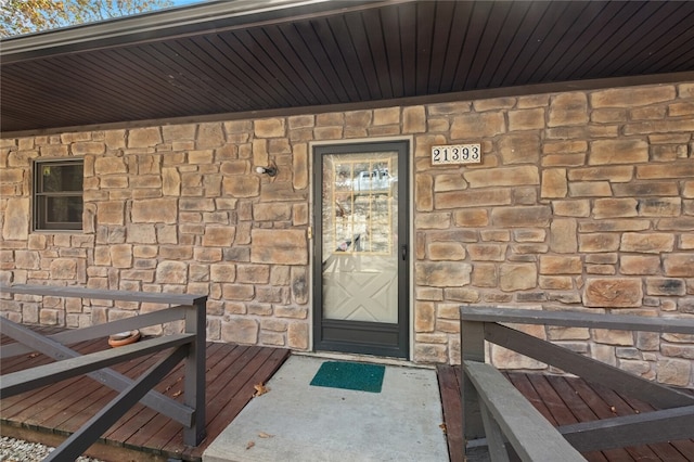 property entrance with stone siding