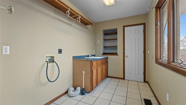 laundry room with sink, electric dryer hookup, cabinets, washer hookup, and a textured ceiling