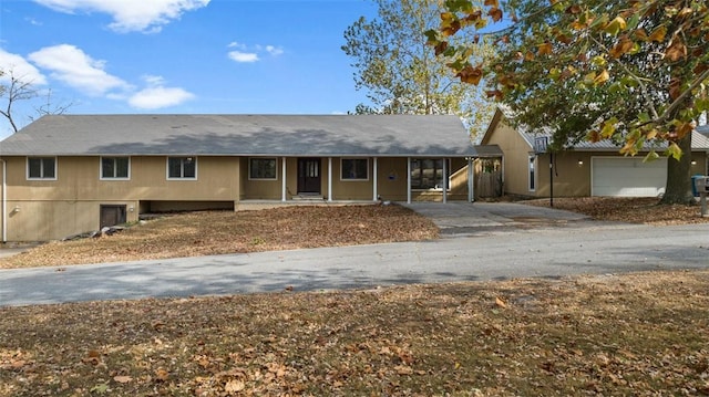 single story home featuring a garage and covered porch