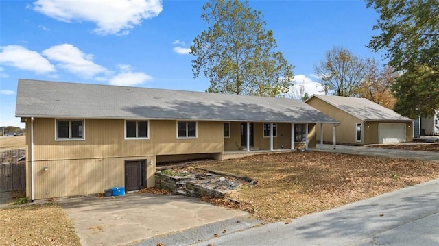 single story home with a garage, an outdoor structure, and covered porch