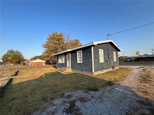 view of side of home featuring a lawn