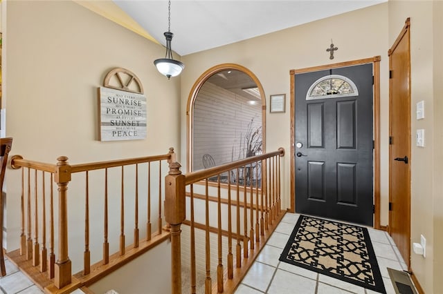 tiled entryway featuring lofted ceiling and visible vents