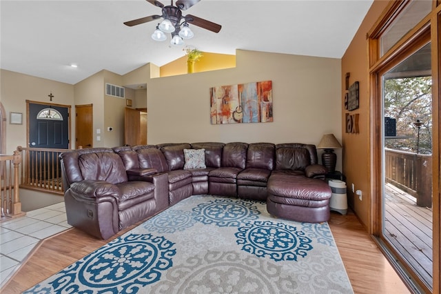 living area with lofted ceiling, light wood-style flooring, visible vents, and a ceiling fan