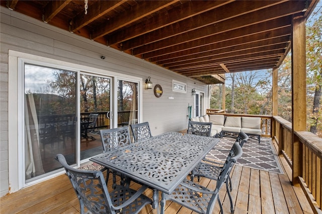 wooden terrace featuring an outdoor living space and outdoor dining space