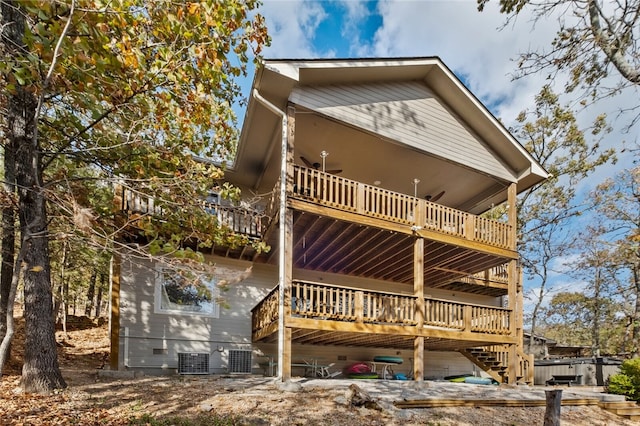 rear view of property with crawl space, a deck, and central AC