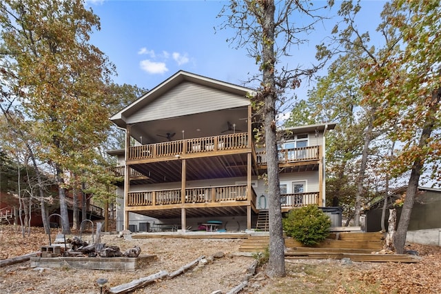 back of property with stairs, a deck, and a balcony