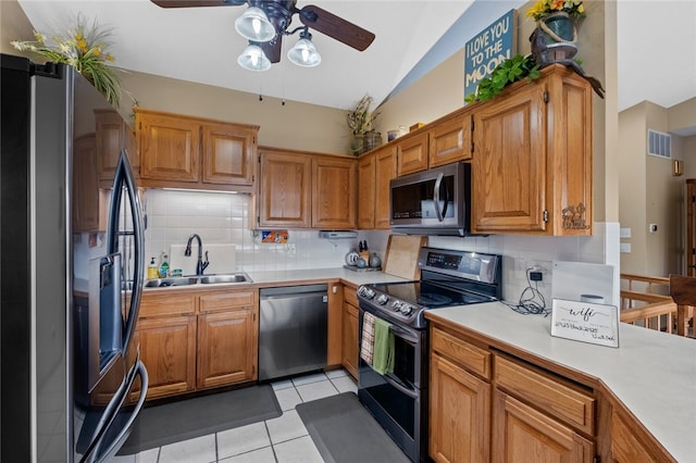 kitchen featuring light tile patterned floors, appliances with stainless steel finishes, light countertops, and a sink