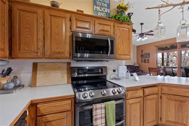 kitchen with brown cabinetry, decorative backsplash, ceiling fan, stainless steel appliances, and light countertops