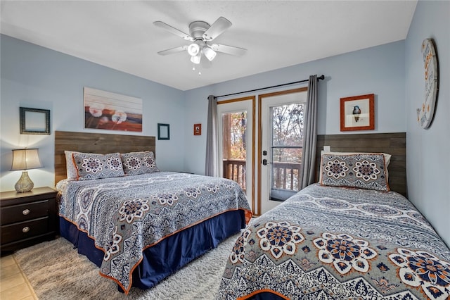 bedroom with ceiling fan, light tile patterned floors, and access to exterior