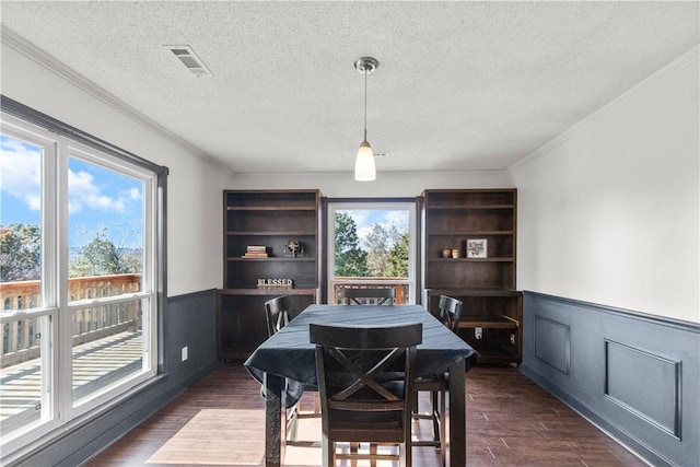 2841 E Hyland Park Rd, Fayetteville, AR 72701 - dining area with a wainscoted wall, a textured ceiling, ornamental molding, and dark wood finished floors
