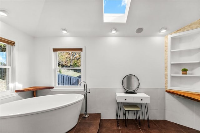 2841 E Hyland Park Rd, Fayetteville, AR 72701 - full bathroom featuring a soaking tub, tile patterned floors, a skylight, and tile walls