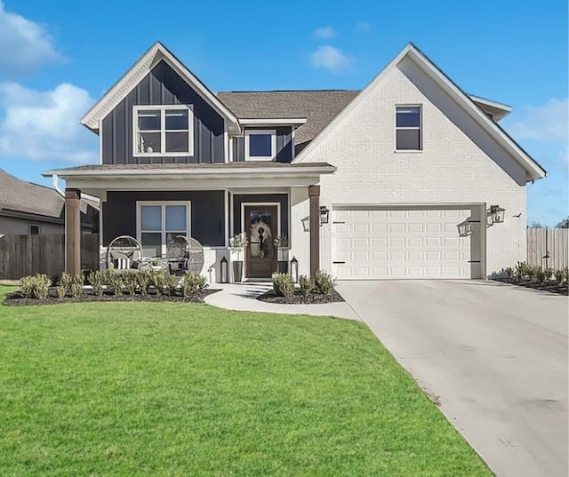 view of front facade with a front lawn, a garage, and a porch