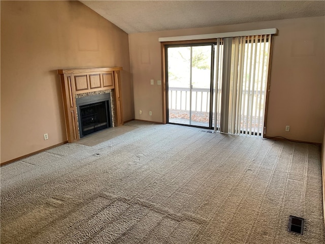 unfurnished living room featuring a textured ceiling, vaulted ceiling, and light colored carpet