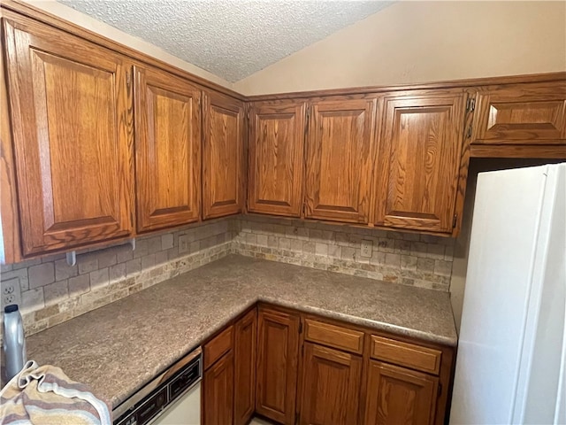 kitchen with white appliances, backsplash, a textured ceiling, and lofted ceiling