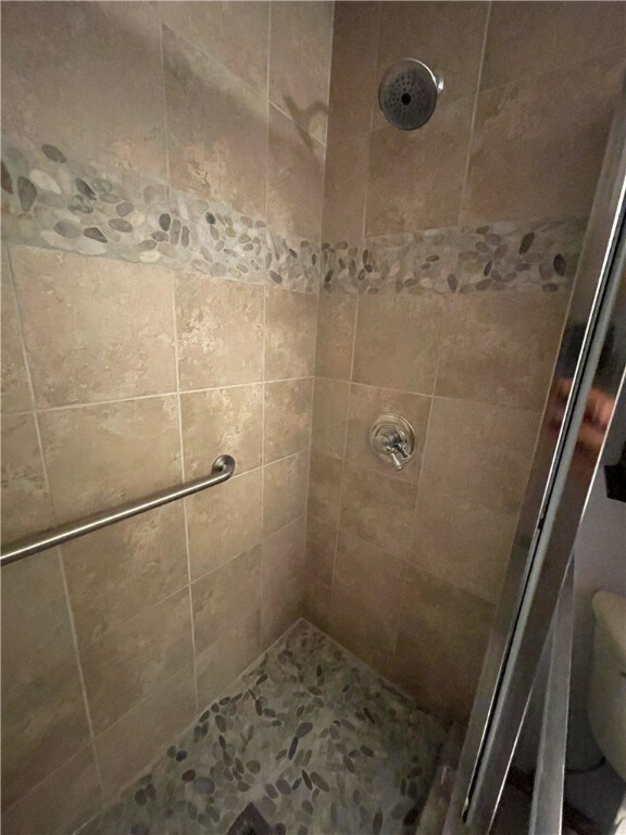 bathroom featuring toilet and walk in shower