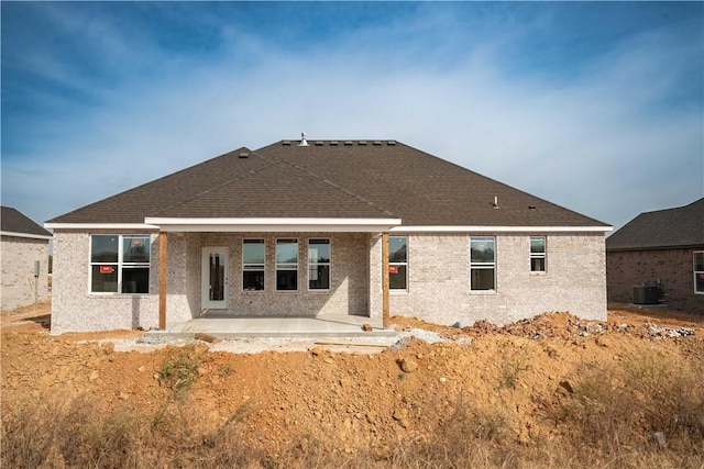 rear view of house featuring central air condition unit and a patio area