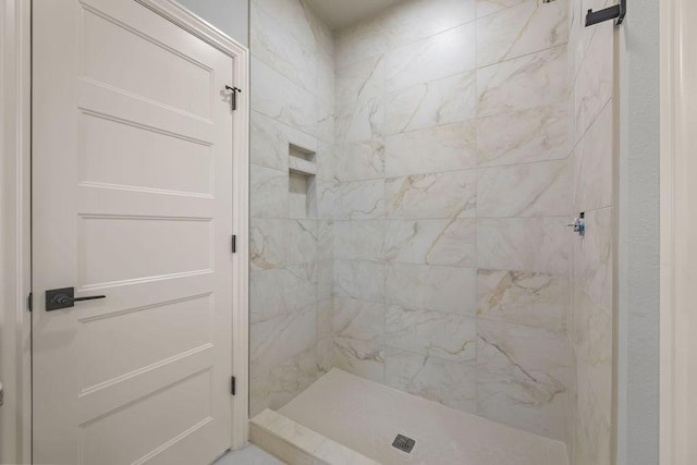 bathroom with a tile shower