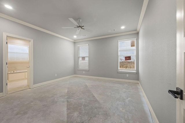 spare room with ceiling fan, concrete floors, and a wealth of natural light