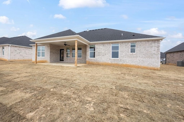 rear view of house with a yard, central AC unit, ceiling fan, and a patio area