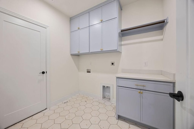 laundry area with hookup for a washing machine, cabinet space, baseboards, and electric dryer hookup