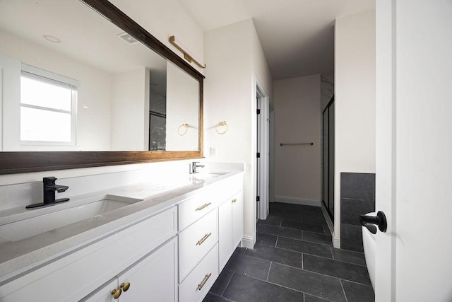 full bath featuring tile patterned flooring, a shower stall, double vanity, and a sink