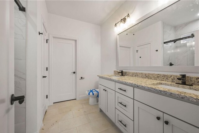 bathroom featuring vanity and a shower with door