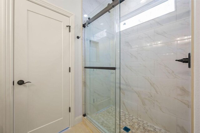 bathroom with a shower with shower door