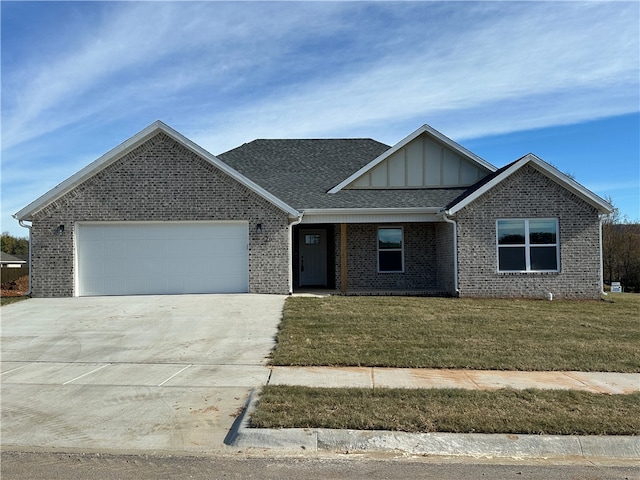 view of front of house with a front yard and a garage