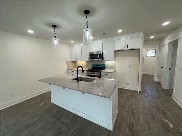 kitchen featuring sink, appliances with stainless steel finishes, decorative light fixtures, dark hardwood / wood-style flooring, and white cabinetry