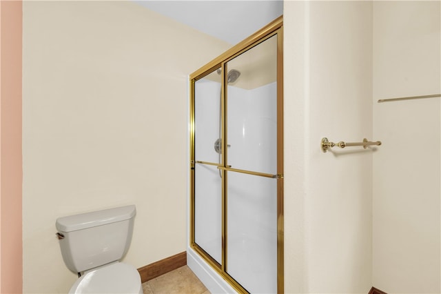 bathroom with a shower with door, toilet, and tile patterned flooring