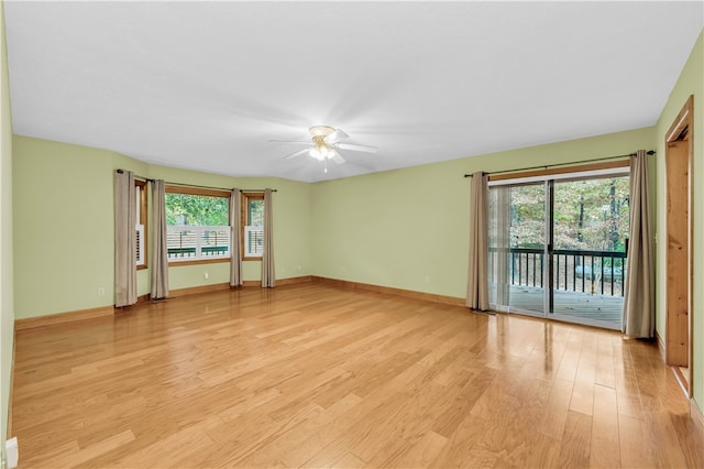 spare room featuring light hardwood / wood-style floors, a healthy amount of sunlight, and ceiling fan