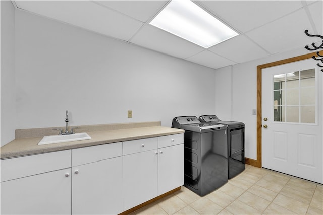 laundry area with cabinets, sink, separate washer and dryer, and light tile patterned floors