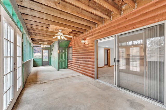 unfurnished sunroom with ceiling fan