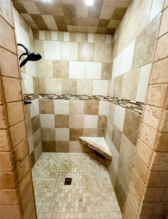 bathroom with a tile shower