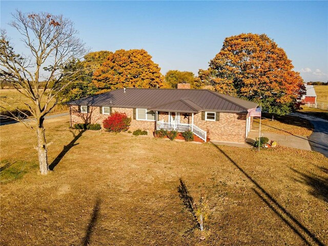 view of front of property with covered porch and a front lawn