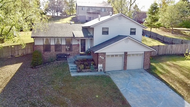 split level home featuring a garage and a front yard