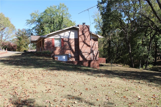 view of home's exterior with a lawn