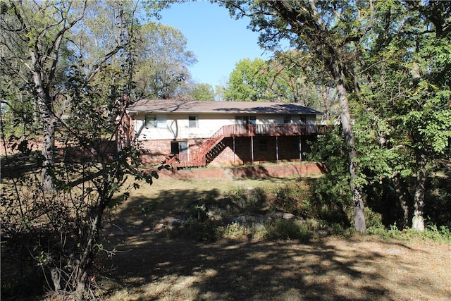 back of house featuring a wooden deck