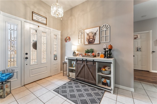 tiled foyer entrance featuring a notable chandelier