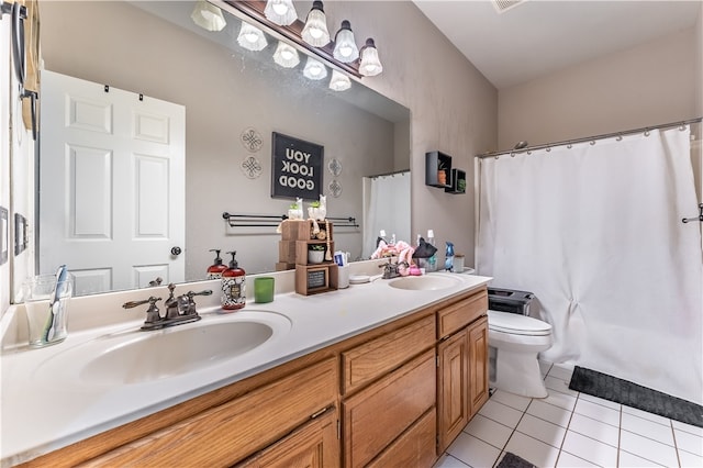 bathroom featuring tile patterned flooring, vanity, and toilet